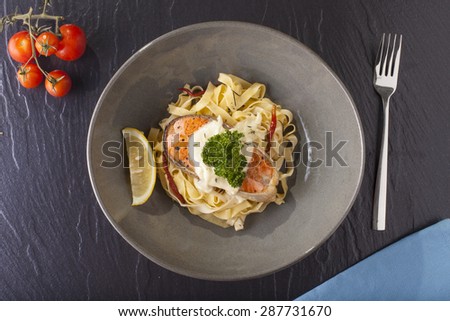 Pasta salmon, fresh seasoning pasta with grilled salmon steak in a decor dish