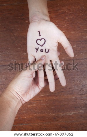 Holding hand i love you, Say I love you by written on a hand.