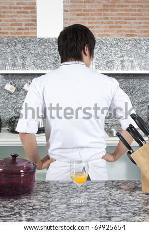 Turn around chef, Chef showing his back or looking for something in the kitchen.