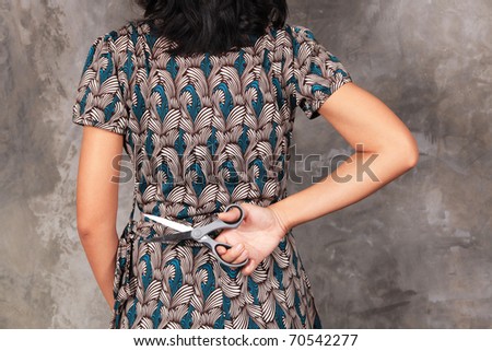 a woman holds scissors , hide the secret