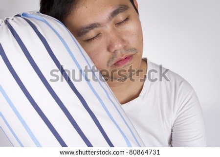 sleepy head, male model sleep on blue stripe bolster.