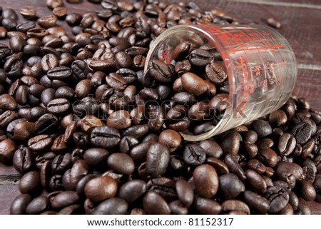 measure glass, measure glass in coffee beans pile.