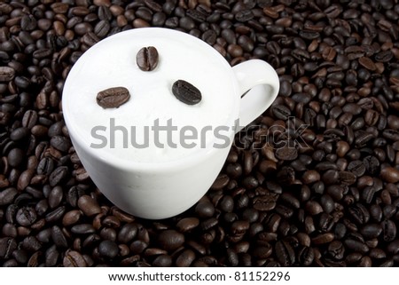 hot latte, glass of hot cafe latte on coffee bean background.