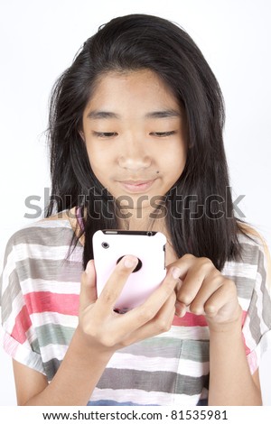 stock photo playing games Asian teen girl playing game on smart phone