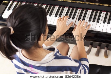 practice piano, asian teenage girl practicing piano.