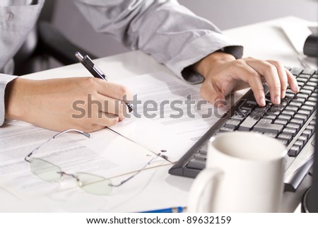 working man, male model working hard, typing keyboard and writing.