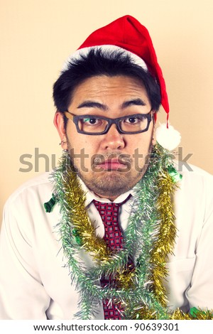 Serious Santa, Business male model with rainbow  paper acting serious Santa.