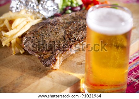steak meal, set of beef steak and beer on the table.
