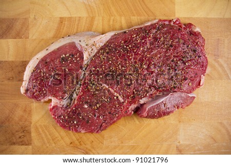 red meat, red fresh meat isolated on wood plate.