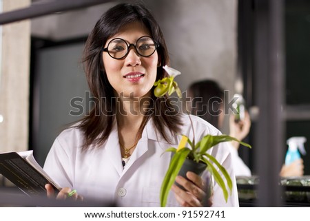 orchid growth, two scientists working in lab about growing plant.