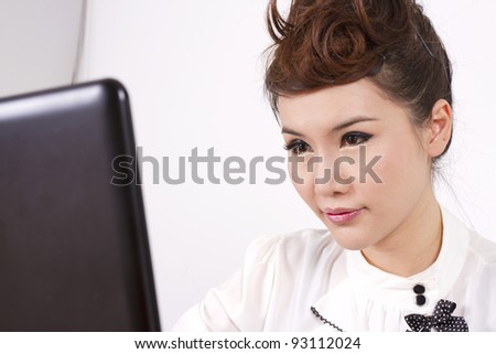 busy mode, female model full make-up working on laptop.