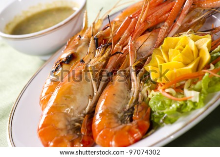 grilled prawns, orange grilled prawn with sour sauce in a dish