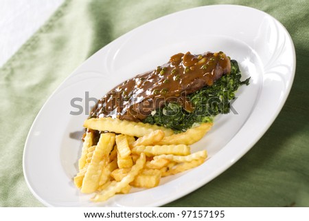 steak, beef steak with brown sauce spinach and french fries