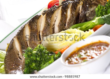 snake fish dinner, dish of whole snake fish steamed with vegetable