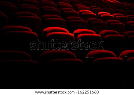 Red back seat in a dark movie theater