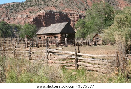 Abandoned old rustic cabin and outbuilding on a mountain farm. Spring/Summer landscape.