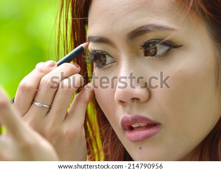 Closeup beautiful woman with eyebrow brush tool