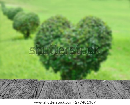 Defocused and blur image of terrace wood and Park with green lawn and dwarfed tree love for background usage