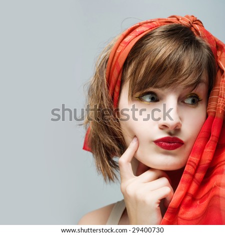 Portrait of a woman with red lipstick and red scarf