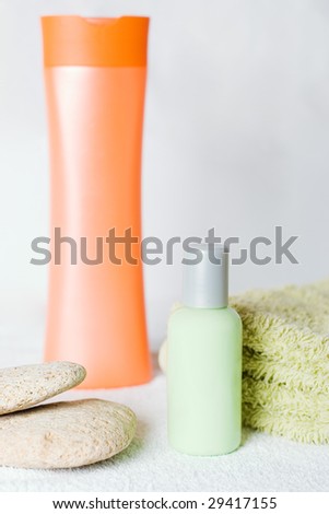 Two bottles of body lotion and a towel