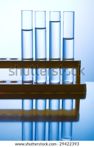 Four chemistry tubes on a yellow stand