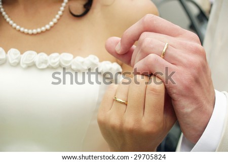 stock photo Young couple holding hands their wedding rings are seeing