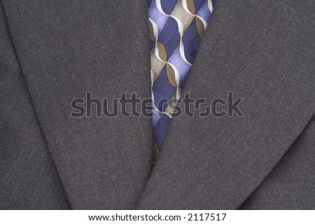 Up close of coat and tie to present a very business and fashion minded photograph.