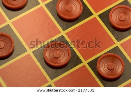 checkerboard with many checkers on it ready to make some moves to win the game.