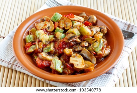 Roasted vegetables on a rustic plate on a fabric napkin