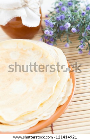 Pancakes with honey on a plate. Tasty dessert