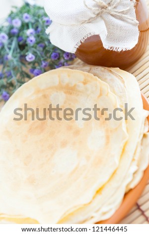 Fresh pancakes with honey on a plate. Fresh and delicious dessert