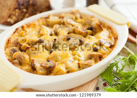 Baked mushrooms, potatoes and cheese. Vegetables closeup