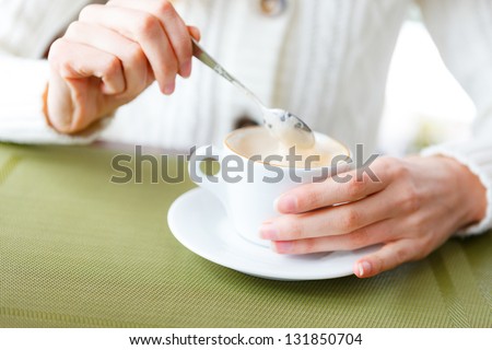 Closeup of cup coffee and woman hands. Cup of hot beverage. Girl on a coffee-break