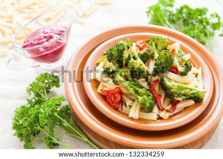 Delicious pasta with roasted vegetables on a plate. Tasty italian food