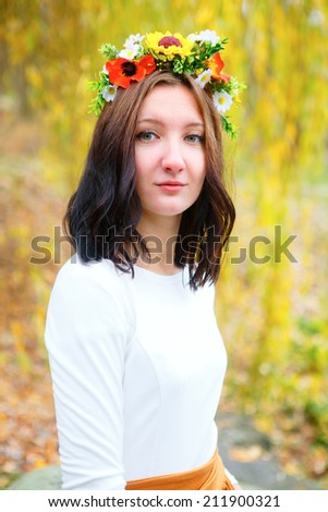 Portrait young girl with flower wreath. Autumn season