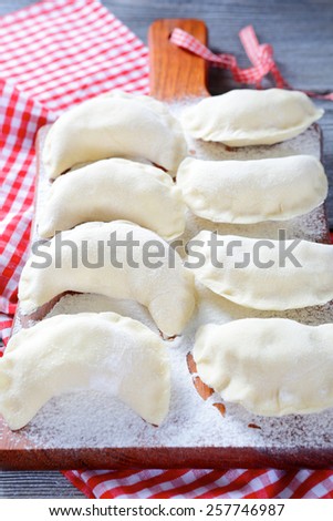 Homemade raw dumplings on the cutting board. Traditional food