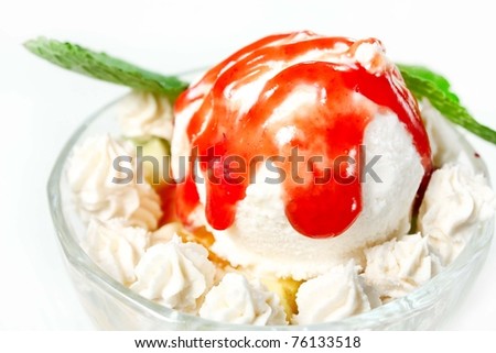Ice cream with strawberry jam, whipped cream and mint leaves