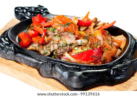 Beef Roast with Vegetables in a decorative pan. Tasty and nutritious food. Isolated on white