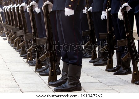 Man in uniform and rifles