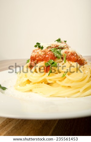 Spaghetti with tomato sauce cheese and parsley