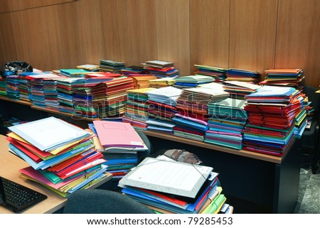 stack of envelops on desks and chairs