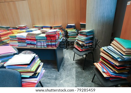stack of envelops on desks and chairs