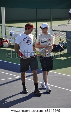 INDIAN WELLS, CALIFORNIA - MARCH  11.    Switzerland\'s Roger Federer chats with a member of his coaching staff during a practice session on March 11, 2010 at the BNP Paribas Open.