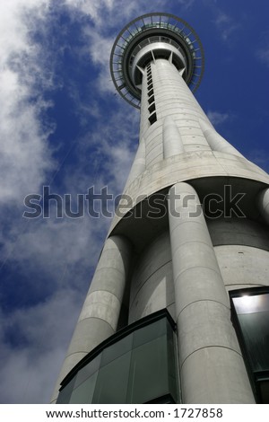 A worm\'s eye view of the Skytower in Auckland, New Zealand.  On the left of the platform, a jumper is falling from the jumping platform.