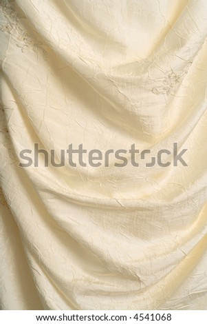 A background image of the flowing fabric of a wedding dress.
