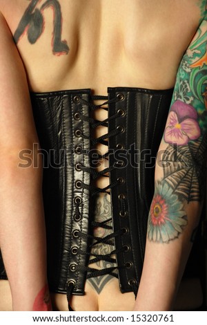 stock photo A young slim women with arm and back tattoos dressed in a 