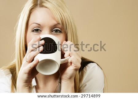 Happy female having a drink of coffee, hot chocolate, or tea.