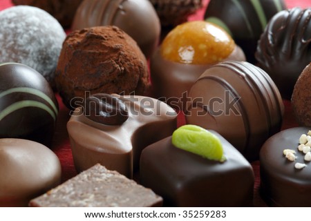 Delicious background of dark chocolates, milk chocolates, pralines and truffles.