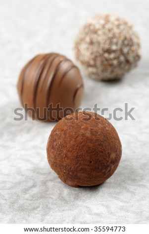 chocolate sweets Stock-photo-three-chocolate-truffles-on-textured-paper-very-shallow-depth-of-field-focusing-on-first-truffle-35594773