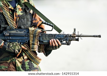 soldier carrying  big gun  in combat training
